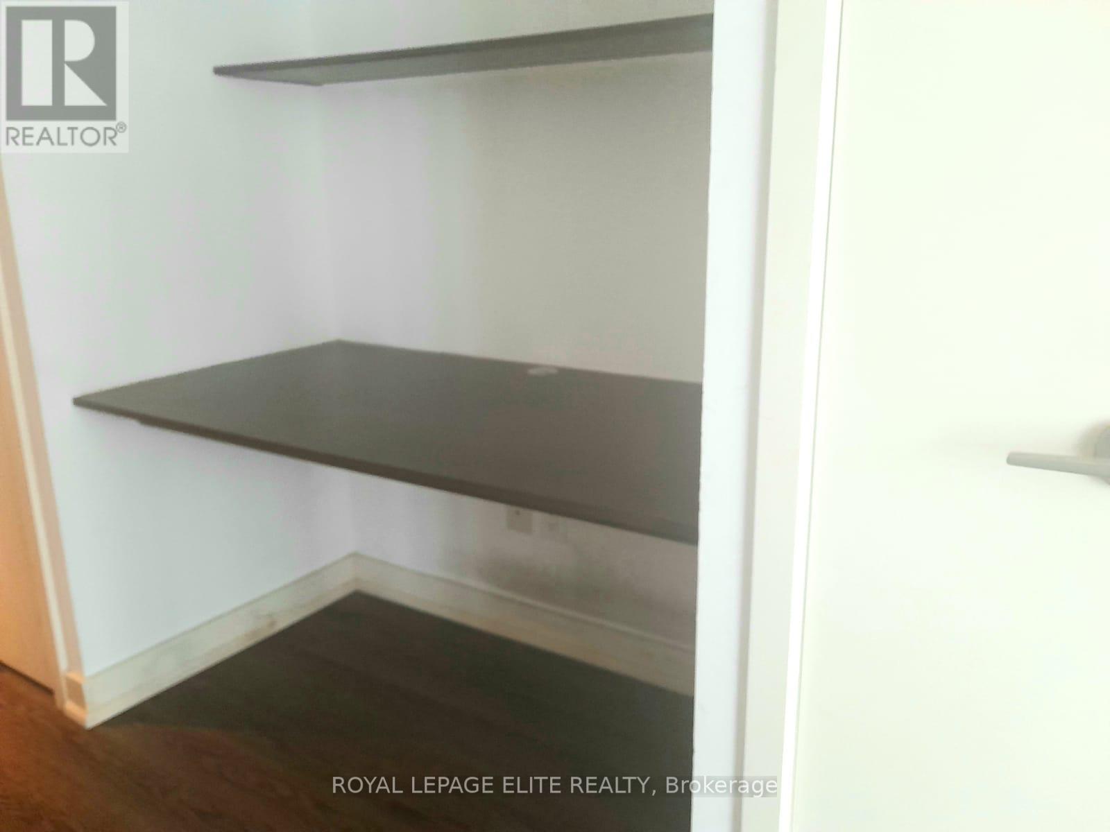 Empty room with shelves and a door.