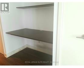 Empty room with shelves and a door.
