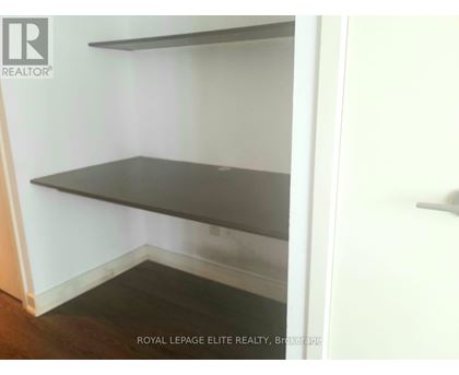 Empty room with shelves and a door.