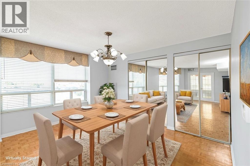 A dining room with a wooden table and chairs.