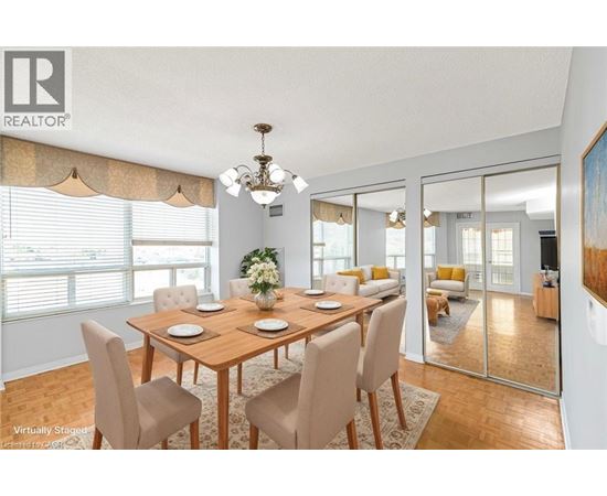 A dining room with a wooden table and chairs.
