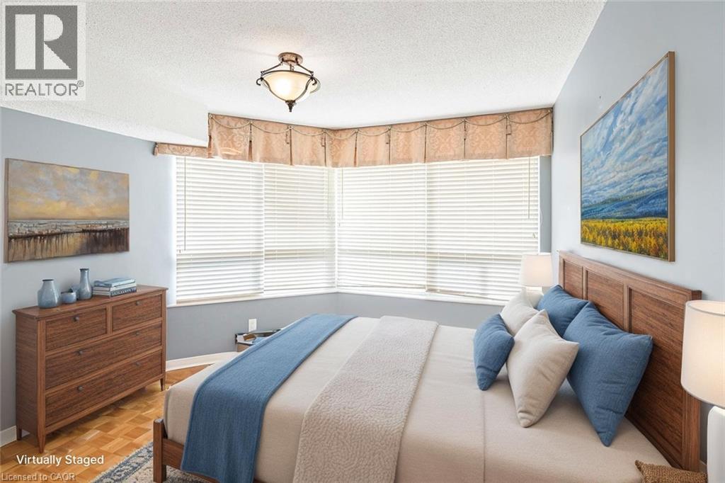 A bedroom with a bed, nightstand, and window with blinds.