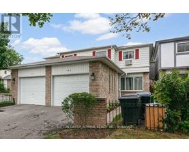 A house with a red stripe on the window and a garage door.