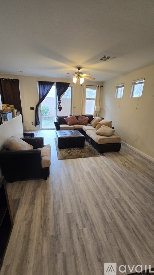 A living room with a couch and a staircase.