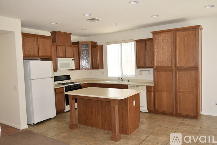 A kitchen with wooden cabinets and a white refrigerator.