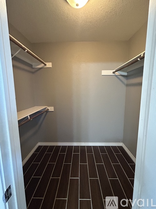 A small, empty room with a tiled floor and white walls.