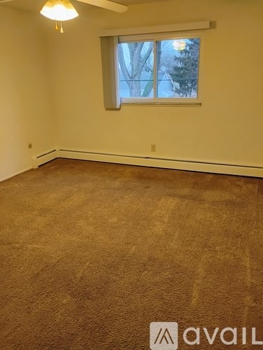 A kitchen with brown cabinets and a white fridge.