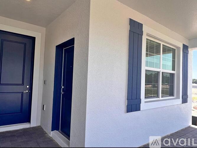 A white house with a blue door and window.