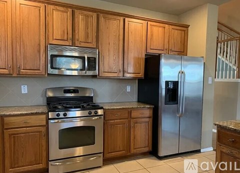 A kitchen with wooden cabinets and stainless steel appliances.