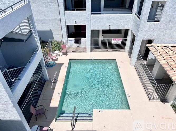 A pool surrounded by apartment buildings.