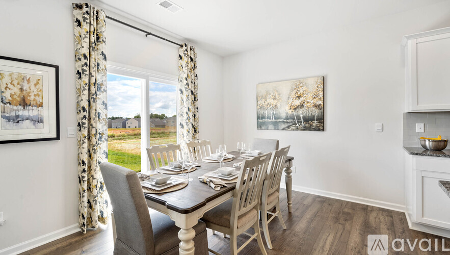 A dining room with a table set for a meal.