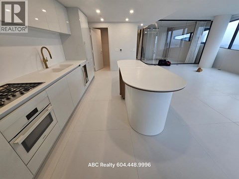 A modern kitchen with a large island in the middle.