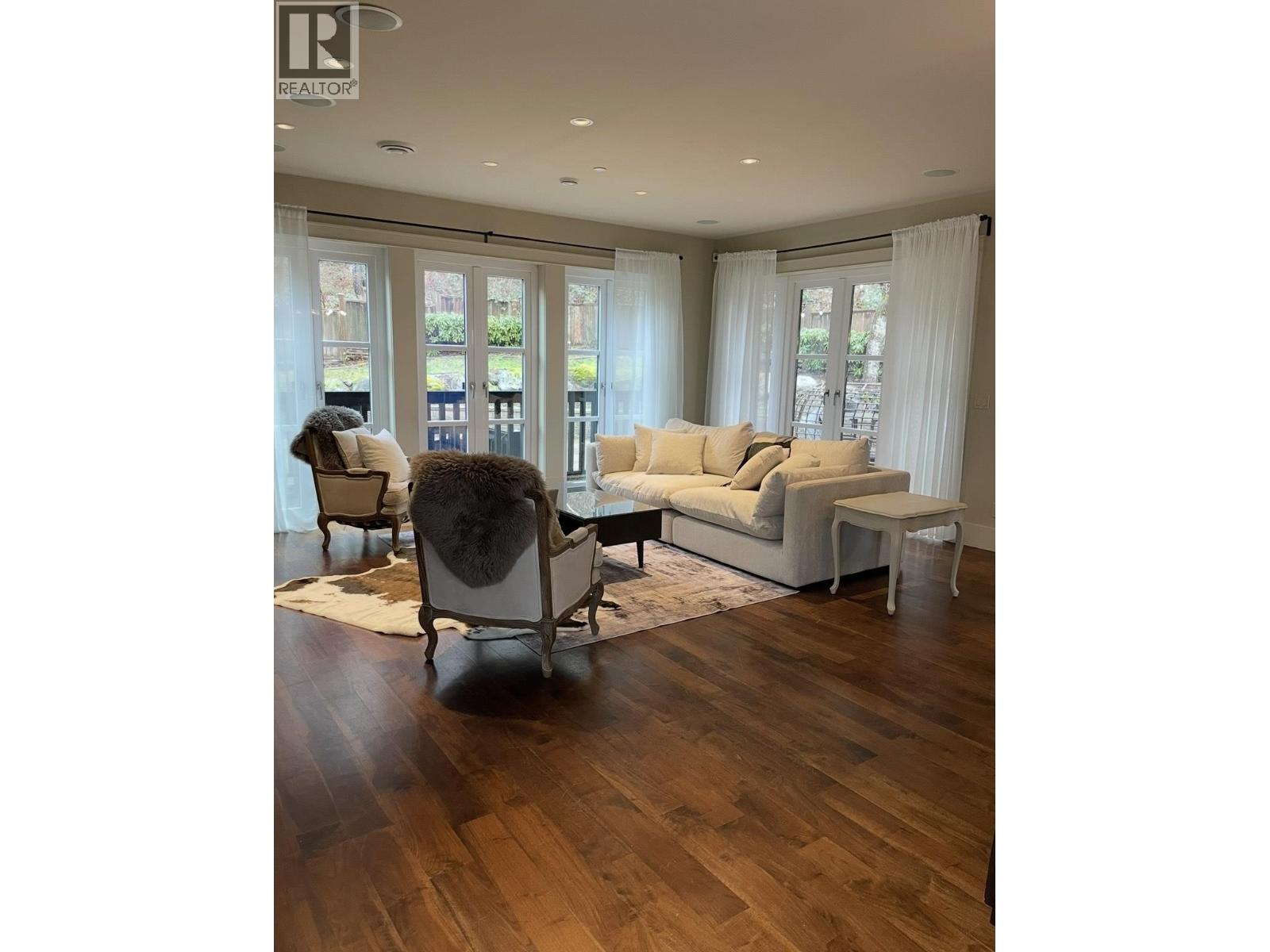 A living room with a couch, chair, and rug.