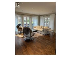 A living room with a couch, chair, and rug.