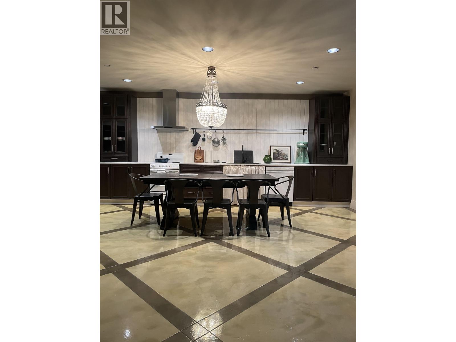 A modern dining room with a large table and chairs.