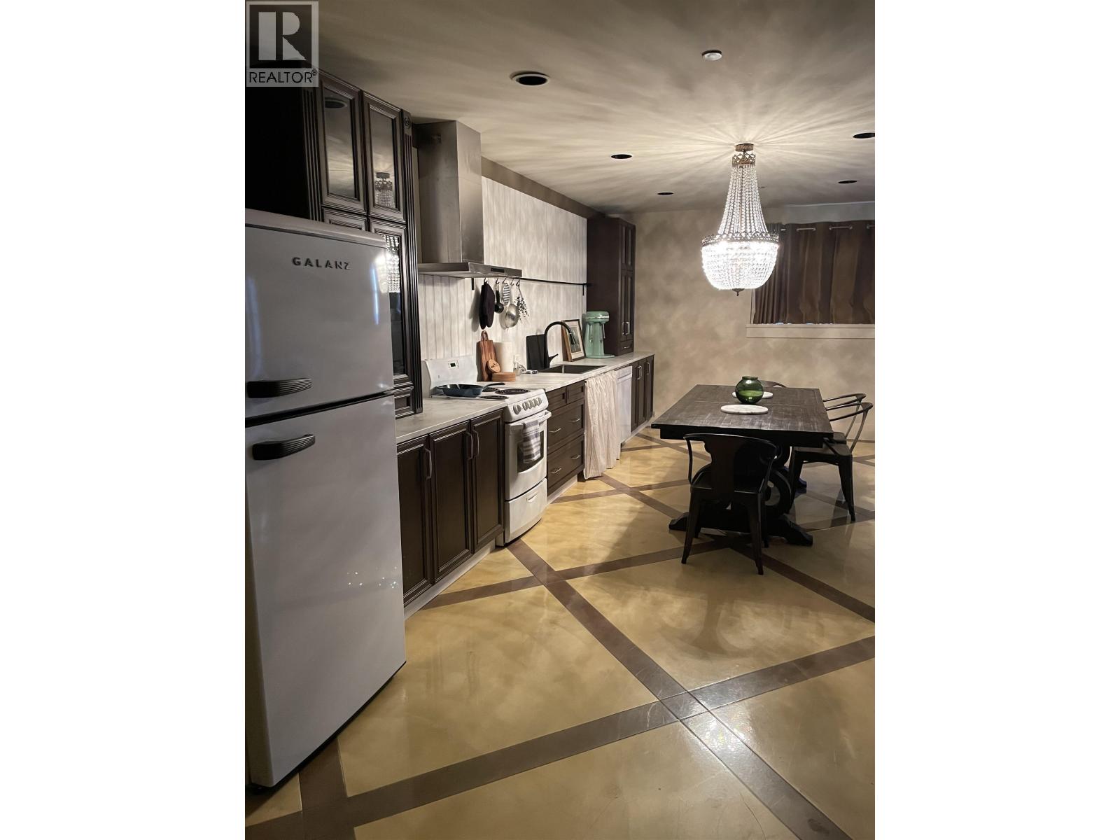 A modern kitchen with a table and chairs.