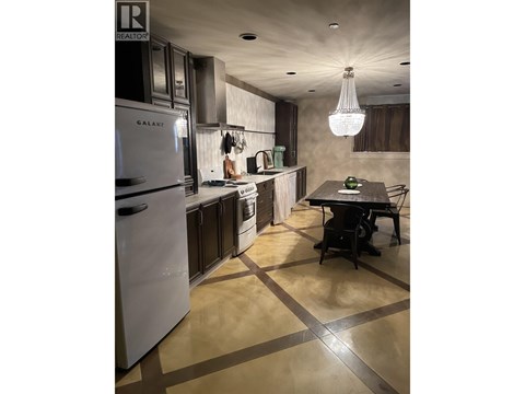 A modern kitchen with a table and chairs.