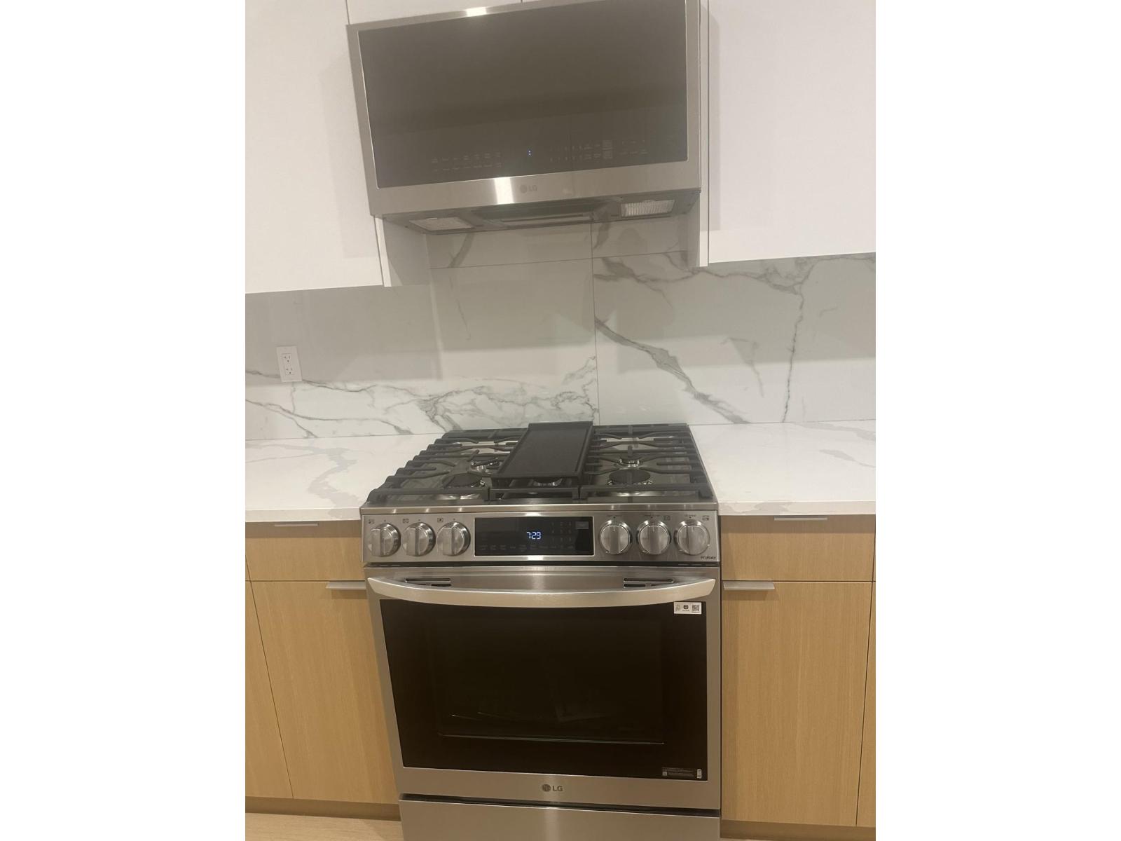 A modern kitchen with a stove top oven.