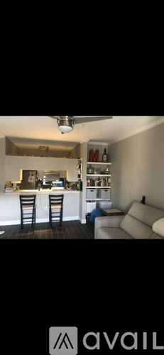 A kitchen with a bar stool and a counter.