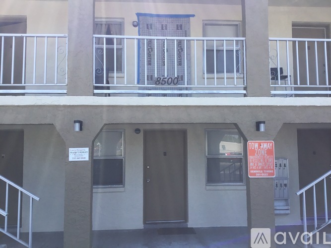 A building with a sign that says "TOW AWAY ZONE" is shown.