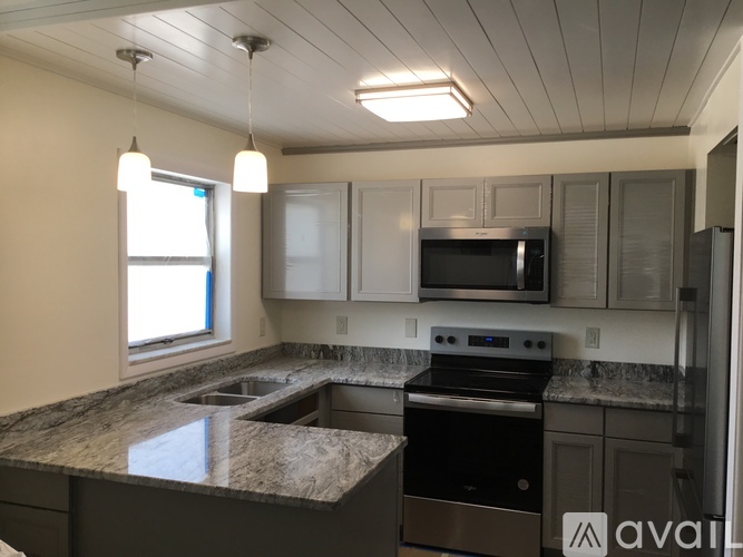 A kitchen with granite countertops and stainless steel appliances.