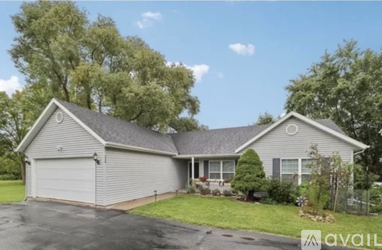 A house with a grey roof and a grey garage door.