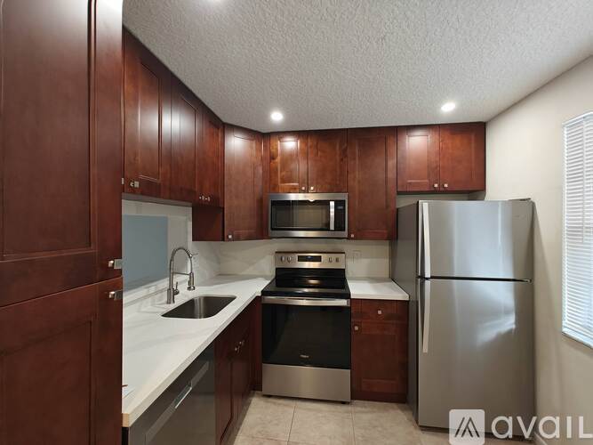 A kitchen with wooden cabinets and stainless steel appliances.
