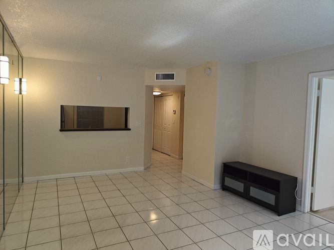 A living room with a bench and a television.