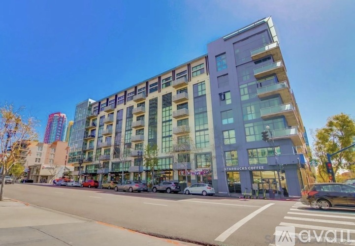 A modern multi-story building with a Starbucks Coffee shop on the ground floor.