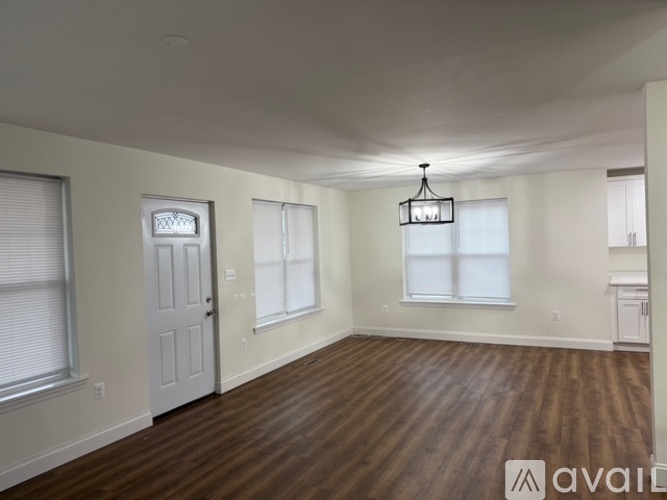 A room with wooden floors and a white door.