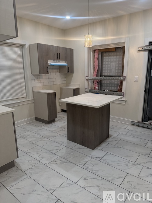 A kitchen with a large island in the middle.