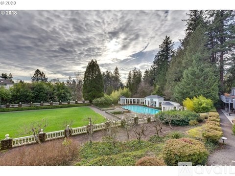 A large house with a pool in the backyard.