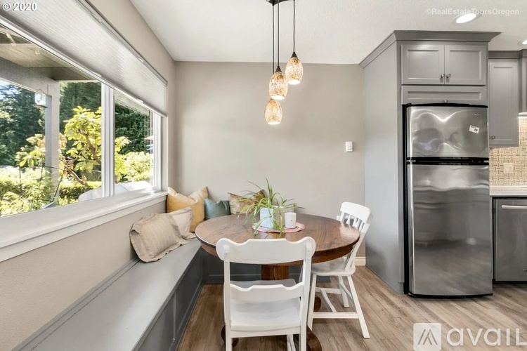 A kitchen with a table and chairs is available for rent.
