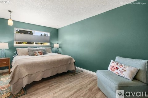 A bedroom with a bed and a couch.