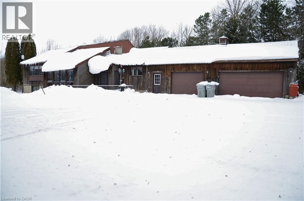 A house with a brown roof covered in snow.