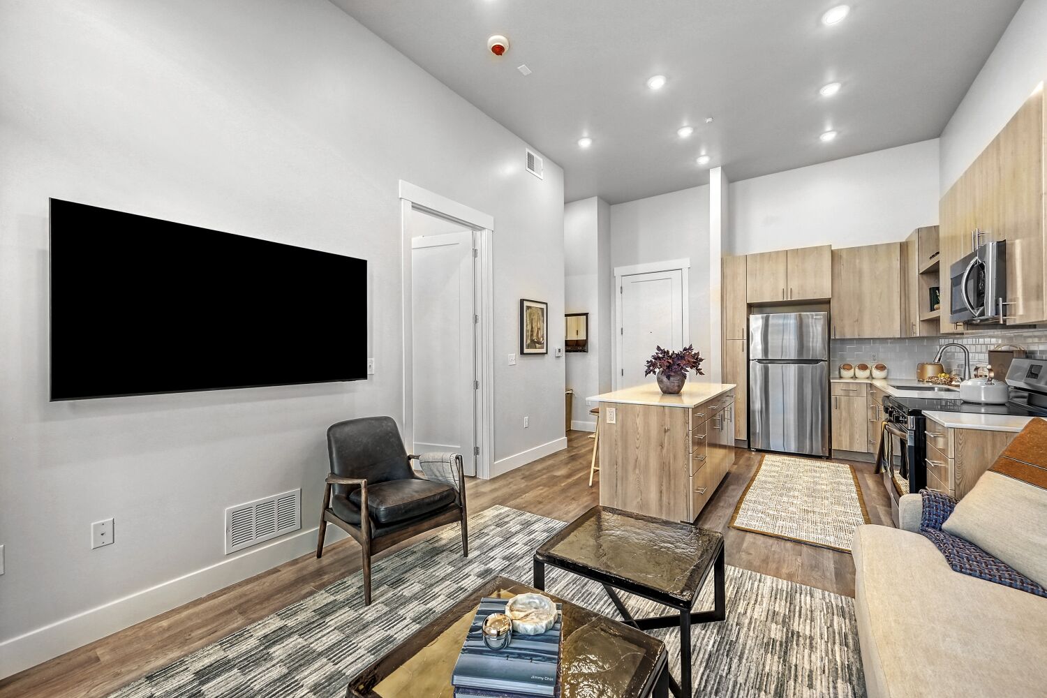 A living room with a black chair and a black table.