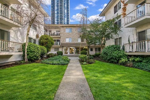 A building with a green lawn in front of it.