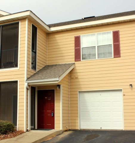 A house with a red door and a white garage door.