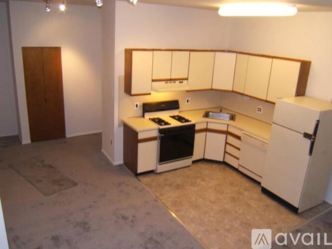 A kitchen with a refrigerator, oven, and microwave.