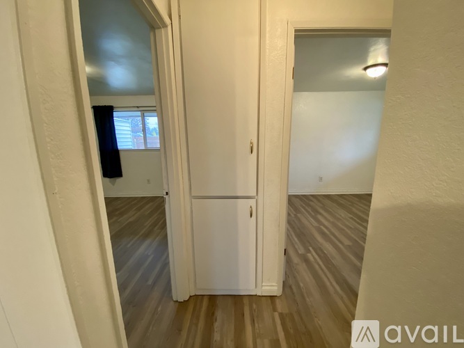A white door with a black handle is open.