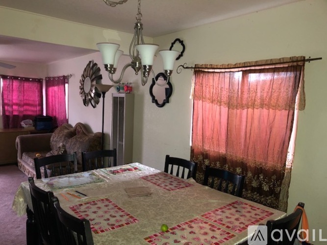 A dining room with a table set for a meal.