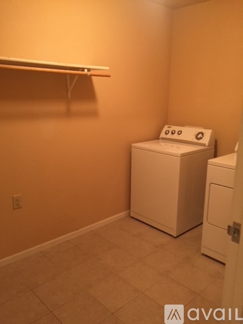 A small laundry room with a washer and dryer.