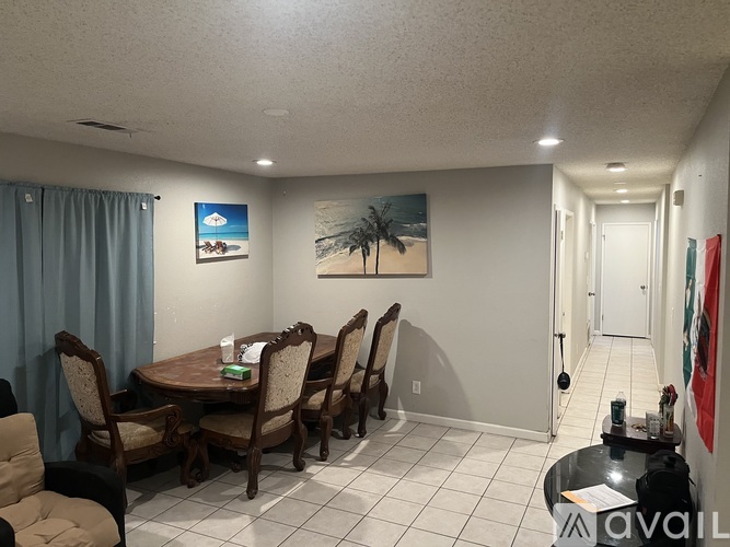 A dining room with a table set for six.