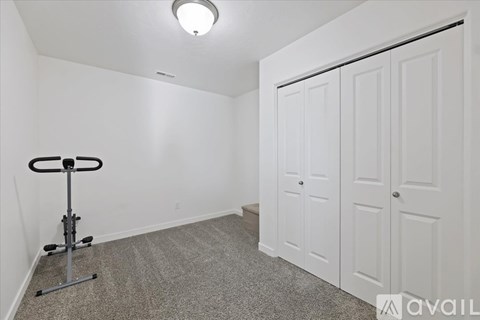 A room with a gym equipment on the floor.