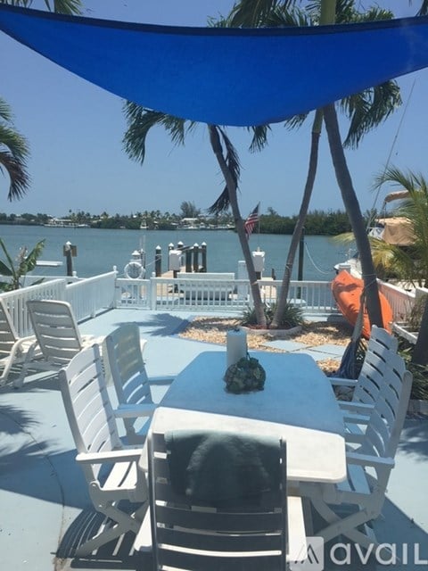 A table with chairs and a pineapple on it.