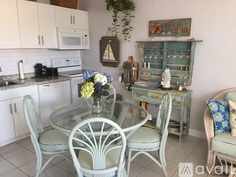 A kitchen with a table and chairs.