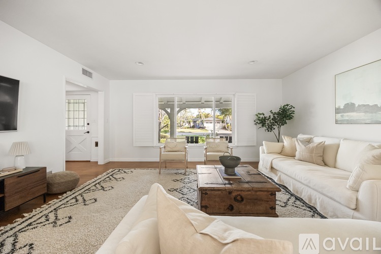 A living room with a white couch and a coffee table.