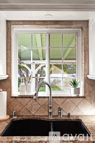 A kitchen sink with a window above it.