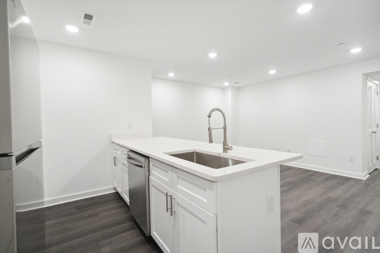 A modern kitchen with white cabinets and a central island.