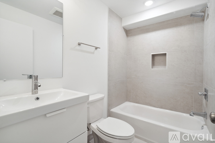 A bathroom with a white sink, toilet, and bathtub.